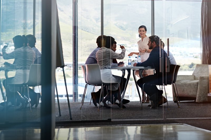 A group of colleagues collaborating together around a table